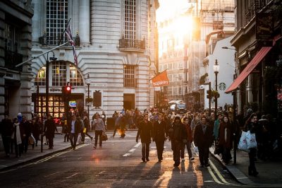 Lots of people walking in the city around evening