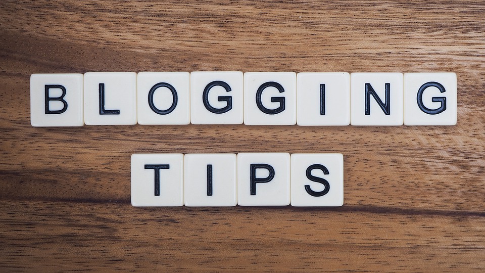 Letter blocks on a table arranged to the words "Blogging Tips"